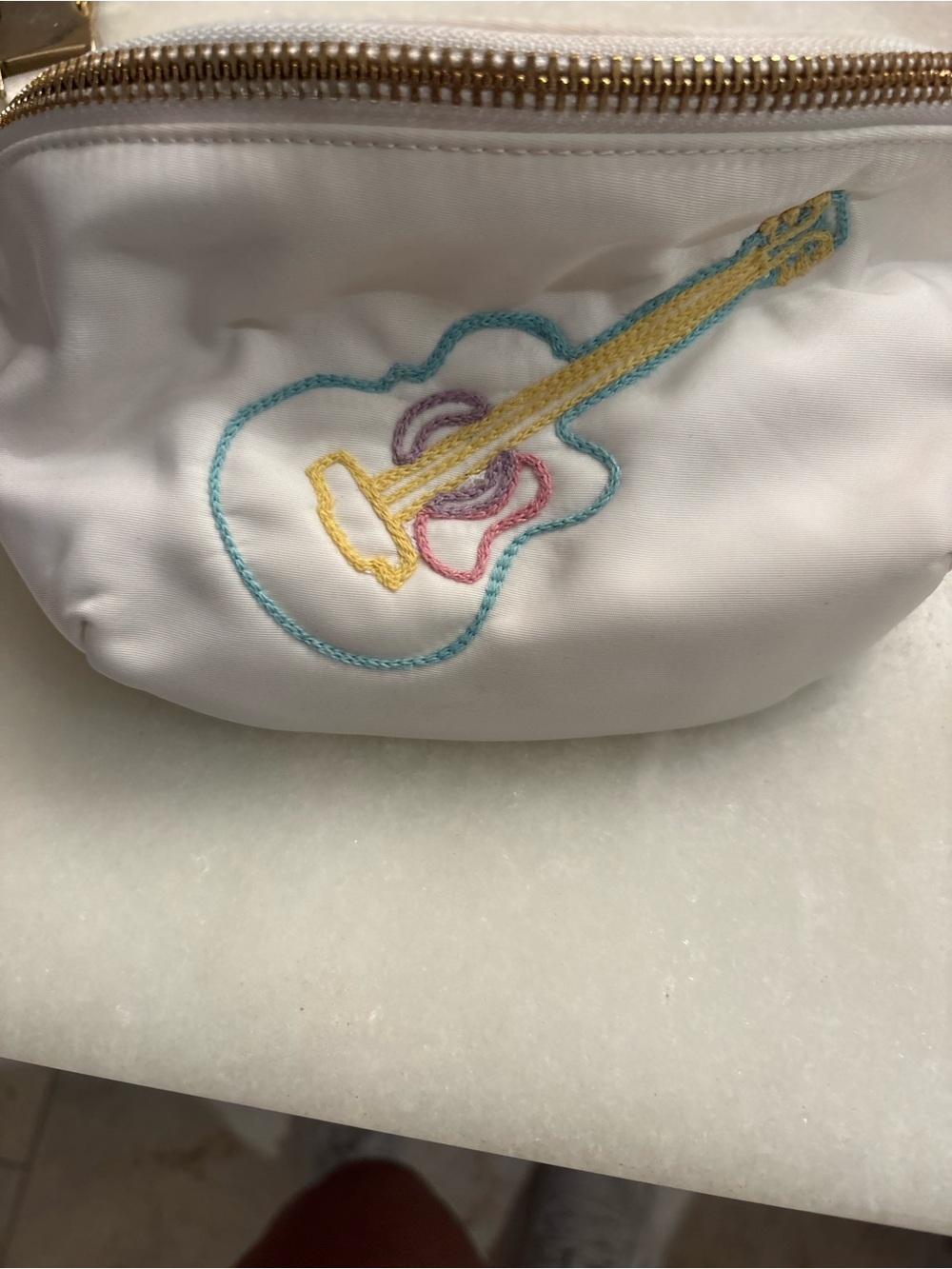 Stoney Clover Lane white pouch with teal, yellow, and pink embroidery
